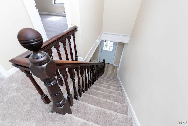 81 E 10th St, Oswego, NY 13126 - staircase with carpet and baseboards