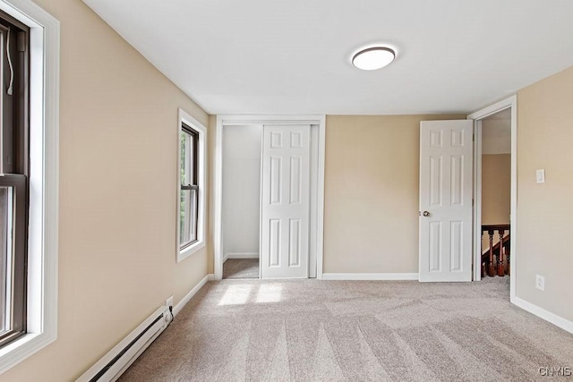 81 E 10th St, Oswego, NY 13126 - unfurnished bedroom with carpet flooring, a baseboard radiator, and a closet