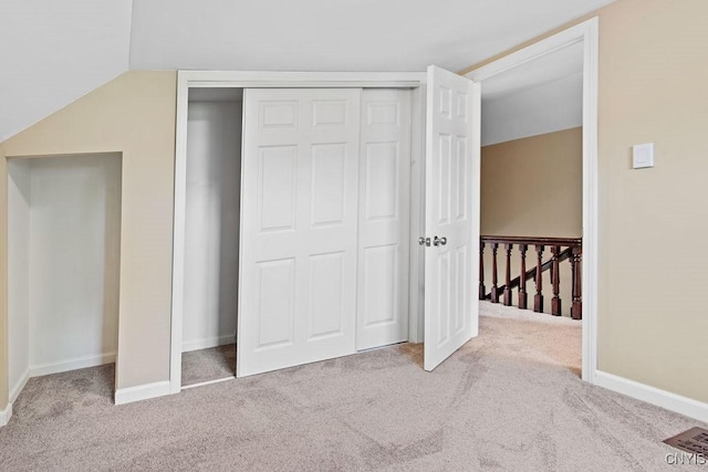 81 E 10th St, Oswego, NY 13126 - unfurnished bedroom with carpet flooring, a closet, and lofted ceiling