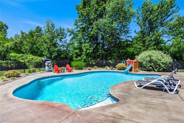 4614 Vrooman Dr, Lewiston, NY 14092 - view of pool featuring a patio, a fenced backyard, a water slide, and view of scattered trees
