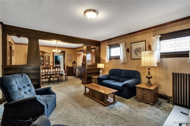 53 Pine Rdg, Cheektowaga, NY 14225 - carpeted living area with radiator, crown molding, wooden walls, and a chandelier