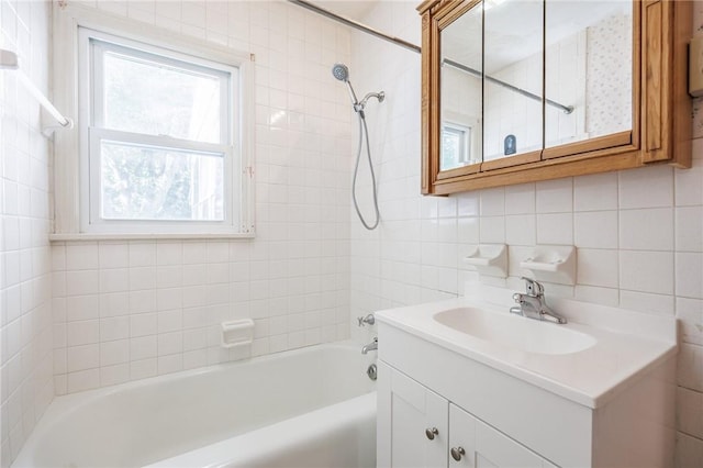 232 W Ivy St, East Rochester, NY 14445 - full bath with vanity, tasteful backsplash, tile walls, and shower / tub combination