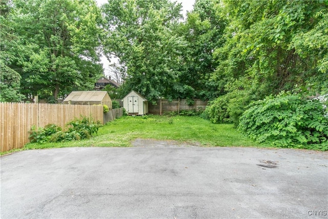 662 Burchard St, Watertown City, NY 13601 - fenced backyard featuring a storage unit and a patio