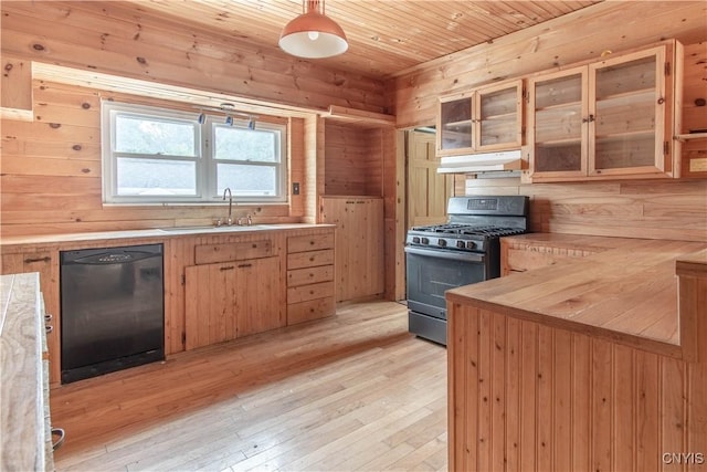 662 Burchard St, Watertown City, NY 13601 - kitchen featuring black dishwasher, stainless steel gas stove, under cabinet range hood, light wood-type flooring, and glass insert cabinets