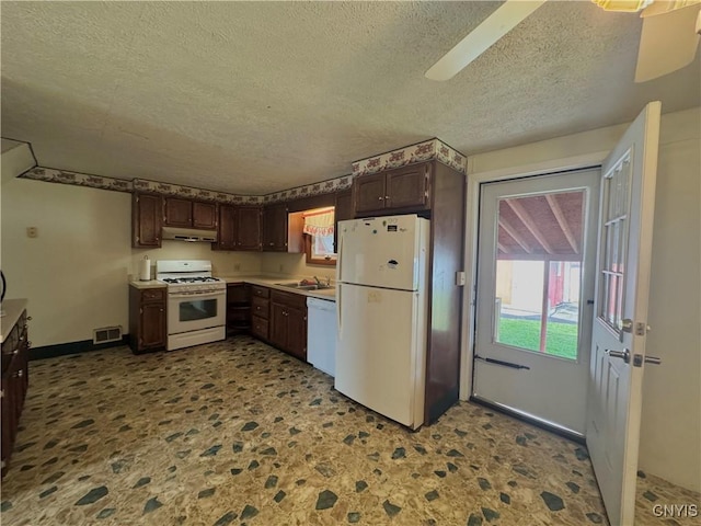 704 Bell Rd S, Rome, NY 13440 - kitchen featuring white appliances, a textured ceiling, under cabinet range hood, dark brown cabinets, and light countertops