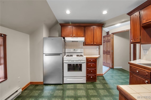 74 Bush St, Buffalo, NY 14207 - kitchen with freestanding refrigerator, a baseboard radiator, white range with gas cooktop, under cabinet range hood, and tile countertops