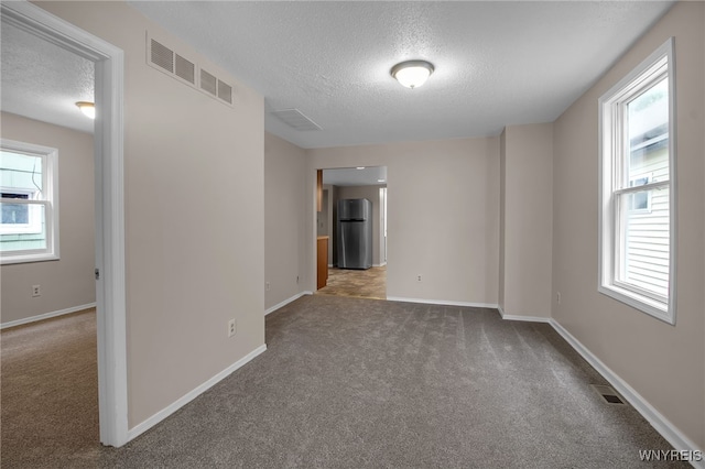 74 Bush St, Buffalo, NY 14207 - carpeted empty room with a textured ceiling and baseboards