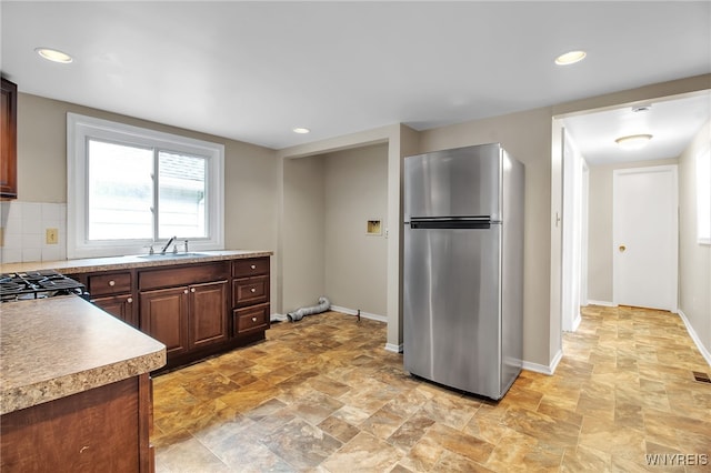 74 Bush St, Buffalo, NY 14207 - kitchen with freestanding refrigerator, light stone finish floors, light countertops, recessed lighting, and stove