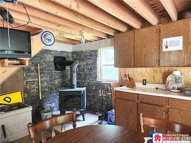8805 Chautauqua Rd, Pomfret, NY 14063 - kitchen with a wood stove, brown cabinetry, and light countertops