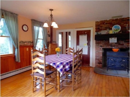 814 County Road 38, Guilford, NY 13733 - dining area featuring a baseboard radiator, light wood-type flooring, healthy amount of natural light, and a chandelier