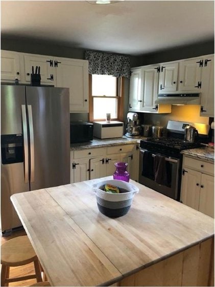 814 County Road 38, Guilford, NY 13733 - kitchen with stainless steel appliances, under cabinet range hood, white cabinets, and light countertops