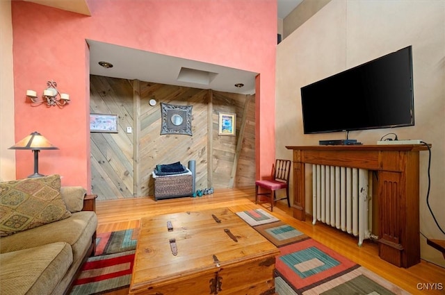4 Jewett Pl, Utica, NY 13501 - living room featuring wood finished floors, wooden walls, and a high ceiling