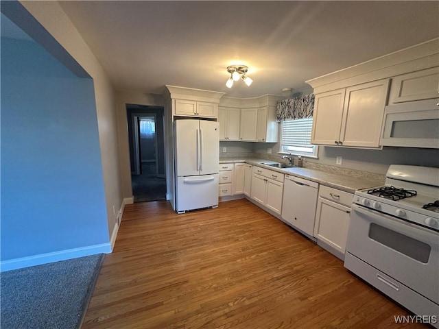 207 Waverly Ave, Tonawanda, NY 14217 - kitchen featuring white appliances, white cabinetry, wood finished floors, and light countertops