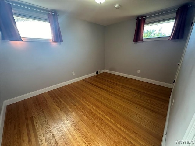 207 Waverly Ave, Tonawanda, NY 14217 - empty room featuring wood finished floors and a smoke detector