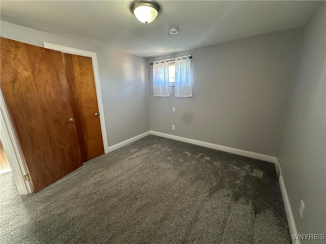 207 Waverly Ave, Tonawanda, NY 14217 - unfurnished bedroom featuring dark carpet and a closet