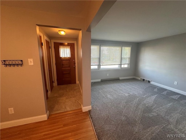 207 Waverly Ave, Tonawanda, NY 14217 - carpeted foyer with baseboards and wood finished floors