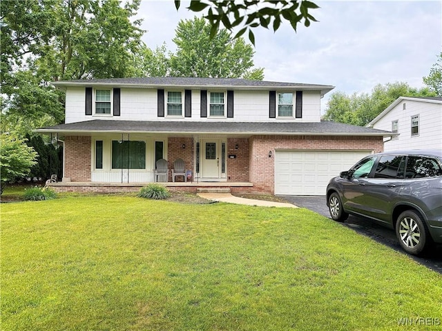 271 Culpepper Rd, Amherst, NY 14221 - view of front of home featuring brick siding, asphalt driveway, a porch, an attached garage, and a front lawn