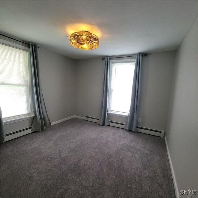 429 S Hamilton St, Watertown City, NY 13601 - carpeted empty room with a baseboard heating unit