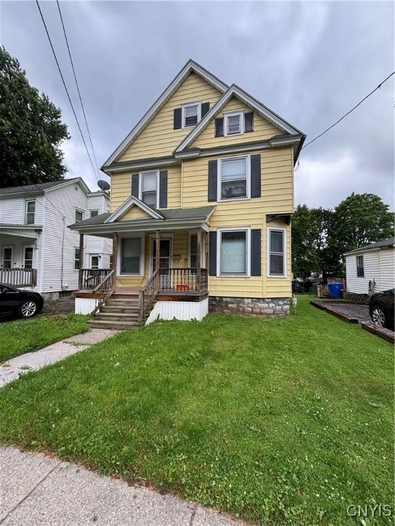 35 Parker St, Auburn, NY 13021 - view of front facade with a porch and a front yard