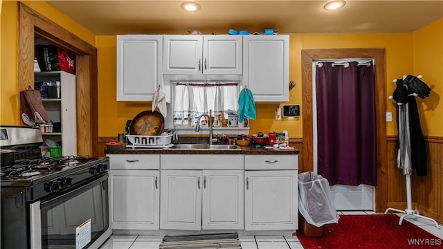 166 Elk St, Buffalo, NY 14210 - kitchen featuring black gas range oven, dark countertops, white cabinets, and recessed lighting