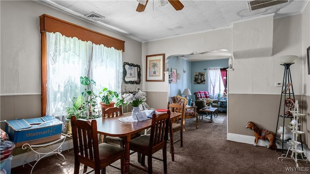 166 Elk St, Buffalo, NY 14210 - dining space featuring arched walkways, carpet floors, a ceiling fan, and wainscoting