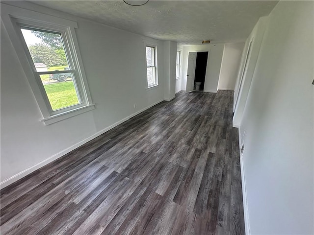 8557 Reeds Corners Rd, Sparta, NY 14437 - spare room with dark wood-style flooring, plenty of natural light, and a textured ceiling
