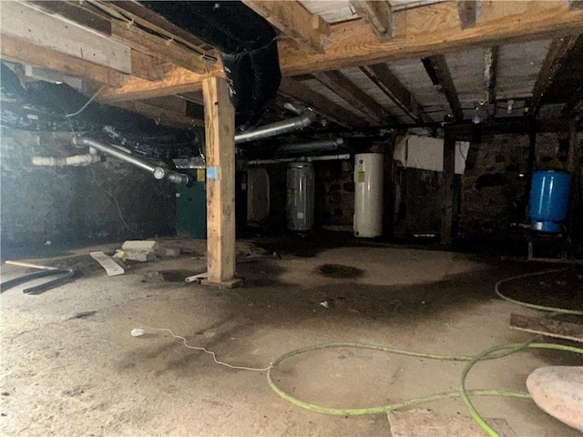 8557 Reeds Corners Rd, Sparta, NY 14437 - basement featuring a water pressure tank, electric water heater, and water heater