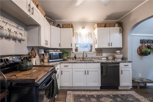 1 Mcbride St, Kirkland, NY 13323 - kitchen featuring black range with electric cooktop, dishwashing machine, stainless steel microwave, dark wood-type flooring, and dark stone counters