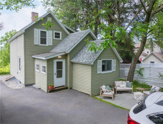 1 Mcbride St, Kirkland, NY 13323 - view of front of house with a patio, a shingled roof, a chimney, and an outdoor hangout area