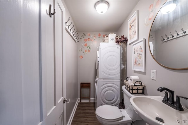 1 Mcbride St, Kirkland, NY 13323 - half bathroom featuring stacked washer / drying machine and wood finished floors