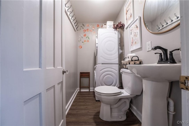 1 Mcbride St, Kirkland, NY 13323 - half bathroom featuring stacked washer and clothes dryer and wood finished floors
