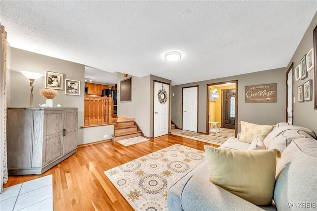17 Treehaven Rd, West Seneca, NY 14224 - living area featuring stairs, light wood-type flooring, and a textured ceiling