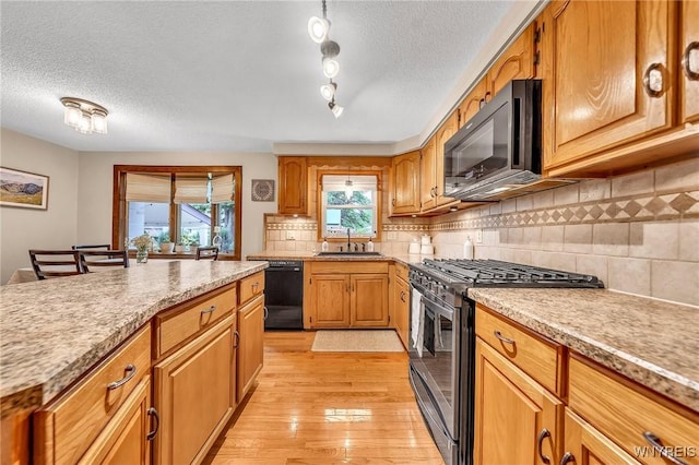 17 Treehaven Rd, West Seneca, NY 14224 - kitchen with black appliances, a textured ceiling, light wood-type flooring, decorative backsplash, and brown cabinets
