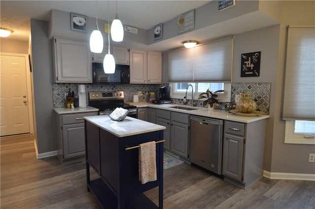 122 Thorn Apple Ln, Greece, NY 14626 - kitchen featuring stainless steel appliances, gray cabinets, light countertops, backsplash, and dark wood-style floors