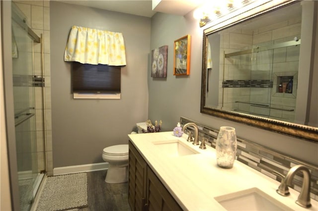 122 Thorn Apple Ln, Greece, NY 14626 - bathroom featuring double vanity, a stall shower, and wood finished floors