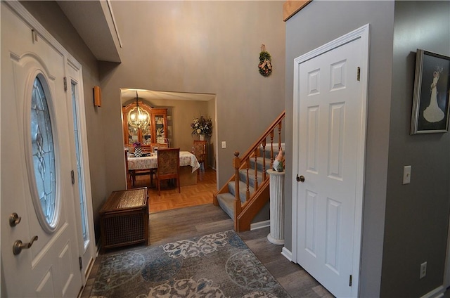 122 Thorn Apple Ln, Greece, NY 14626 - entryway featuring stairs, a chandelier, and dark wood-type flooring