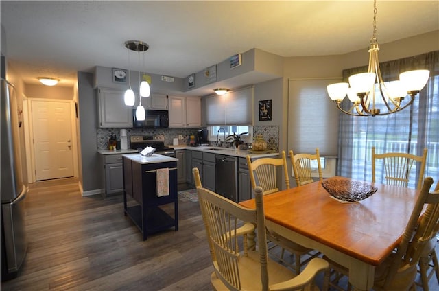 122 Thorn Apple Ln, Greece, NY 14626 - dining room featuring dark wood-style flooring and a chandelier