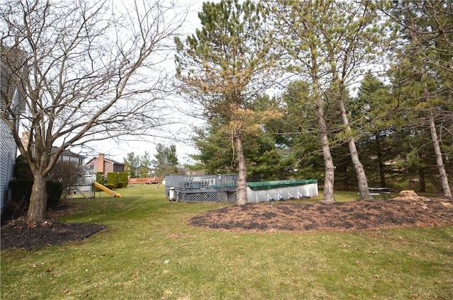 122 Thorn Apple Ln, Greece, NY 14626 - view of grassy yard with a deck, a playground, and a covered pool