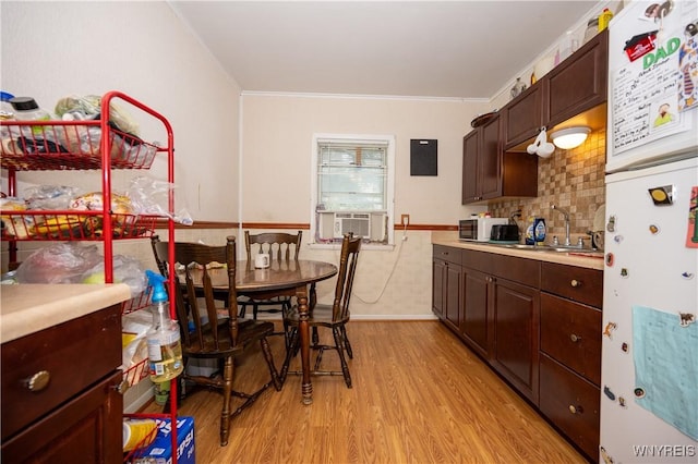 13 Highland Pl, Lancaster, NY 14086 - kitchen featuring freestanding refrigerator, light wood finished floors, light countertops, crown molding, and a wainscoted wall