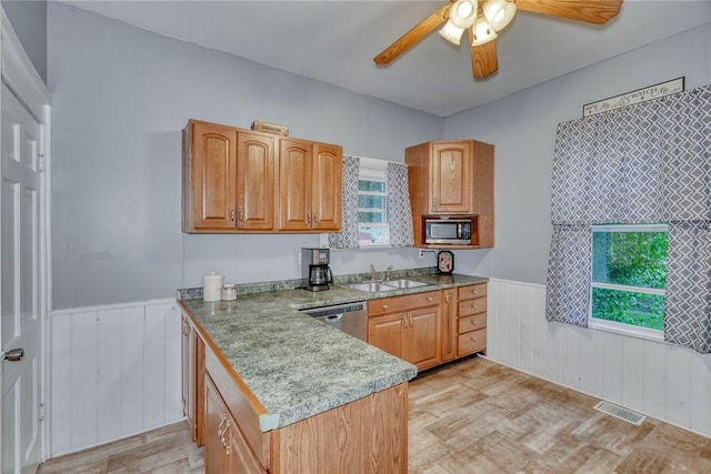 2360 Harris Rd, Palmyra, NY 14522 - kitchen featuring wainscoting, appliances with stainless steel finishes, ceiling fan, a peninsula, and brown cabinets