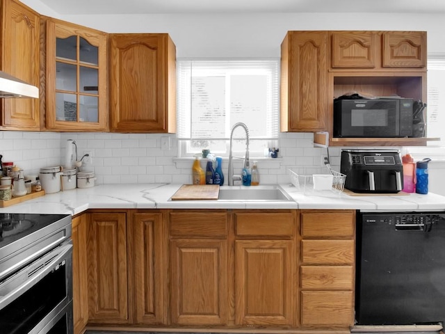 449 Pinnacle Rd, Henrietta, NY 14623 - kitchen featuring black appliances, decorative backsplash, glass insert cabinets, and brown cabinets