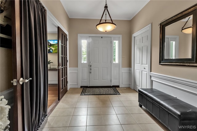 4901 Pineledge Dr W, Clarence, NY 14031 - foyer with wainscoting, light tile patterned floors, and a decorative wall
