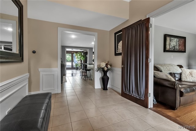 4901 Pineledge Dr W, Clarence, NY 14031 - hallway featuring light tile patterned flooring and a wainscoted wall