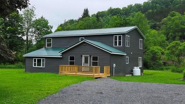 27 Watson Farm Rd, Summit, PA 16720 - back of property featuring a wooden deck, a yard, a forest view, and a metal roof