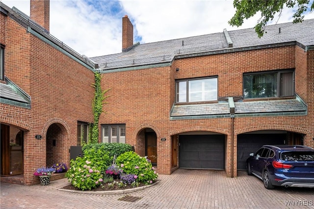 176 Rivermist Dr, Buffalo, NY 14202 - view of front of house featuring brick siding, a high end roof, a garage, and driveway