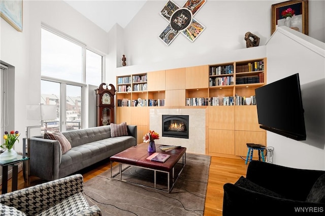 176 Rivermist Dr, Buffalo, NY 14202 - living room featuring high vaulted ceiling, wood finished floors, and a tile fireplace
