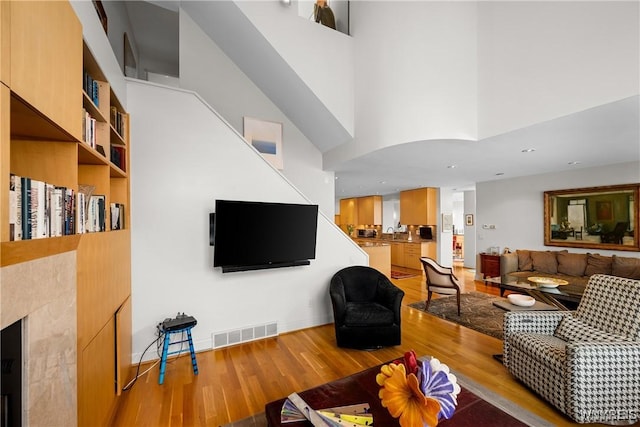 176 Rivermist Dr, Buffalo, NY 14202 - living area featuring light wood finished floors and a towering ceiling