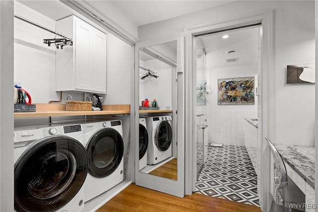 176 Rivermist Dr, Buffalo, NY 14202 - laundry room with independent washer and dryer, light wood-style floors, and cabinet space