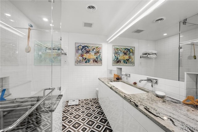 176 Rivermist Dr, Buffalo, NY 14202 - bathroom featuring tile walls, vanity, and a stall shower