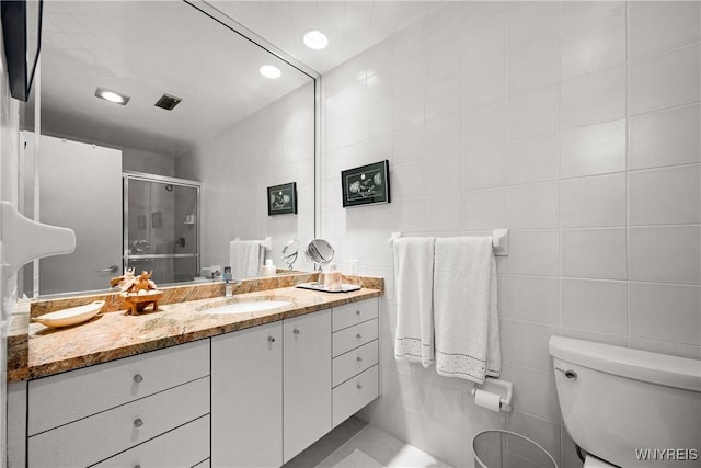 176 Rivermist Dr, Buffalo, NY 14202 - bathroom featuring tile walls, vanity, a stall shower, and recessed lighting